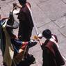 Monks offering alcohol for the propitiation of the earth deities to the"Black hat (zhva nag)" dancers, (monks), Paro Tshechu (tshes bcu), 1st day, in the dzong.