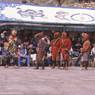 The hunter Gonpo Dorje beating his servant Acho Pento while other atsara are looking on, dance of Milarepa (Sha ba sha khyi 'cham), Paro Tshechu (tshes bcu), dance arena, Paro Tshechu (tshes bcu), 2nd day