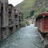 Concrete and wooden houses along river in downtown Derge [sde dge].