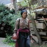 Tibetan woman with rosary in left hand.
