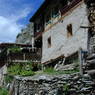 Tibetan house high on hillside.