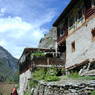 Tibetan house high on hillside.
