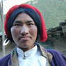 Young Khampa man with red hair tassle.