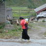 Tibetan woman with child on back.