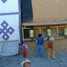 Tibetan children spinning prayer wheels outside the Assembly Hall.