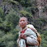 Tibetan boy with child on back.