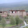 Tibetan house made of earthen walls and logs.