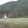 A large white stupa on the outskirts of Tawu.