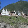 A row of stupas alongside a road.