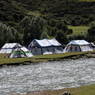 A Tibetan encampment alongside a river.