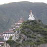 A stupa at Pelyul Monastery, with the monastery Temple in the background.