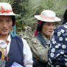 Tibetan women wearing hats and turquoise hair ornaments.