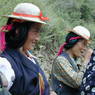 Tibetan women wearing hats and turquoise hair ornaments.