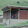 Tibetan children on the porch of a Tibetan house.