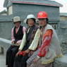 Tibetan women sitting on a bridge.