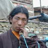 A Tibetan nomad young man holding a turquoise rosary.