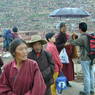 Local Tibetans and  Chinese tourists on the roadside.