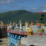 Ceramic statues of external deities on the perimeter of an upper level of the Gyutrul Temple representing a mandala of deities.
