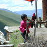 Young Tibetan girl on the hillside of the Larung Gar [bla rung gar] Nunnery.