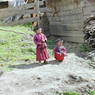 Two young monks outside a monastic residence.