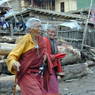 Elderly nuns walking near the Assembly Hall ['du khang].