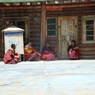 Monks sitting in the courtyard of the residence of Khenpo Jigme Phuntsok, the founder of Larung Gar.