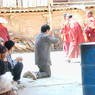 A Chinese man bowing to Tibetan monks while waiting to see Khenpo Jigme Phuntsok, the founder of Larung Gar.