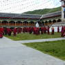 Monks debating religious topics in the courtyard of the college.