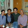 Tibetan family members having tea in the living room.