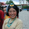 A Tibetan woman wearing a turquoise hair ornament and necklace.