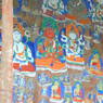 Close-up of carvings of buddhas in the rock face.