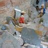 Tibetan children working on carving prayer stones.