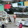 Pilgrims at the pile of prayer flags and prayer stones.