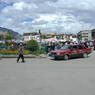 A taxi on the edge of the plaza in front of the Jokhang; the temple is visible in the background.