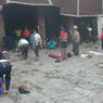 Tibetans prostrating in the courtyard before the entrance portico of the temple.