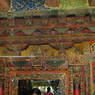 Close-up of an intricately carved and painted door frame.