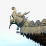 A sculpture of a water spirit on the corner of one of the temple roofs.