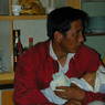 A Tibetan man visiting the family with his young child.