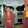 Three monks on the second floor balcony of the Assembly Hall.