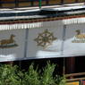 A banner depicting deer and a wheel of the Dharma hung above the main entrance to the Assembly Hall.