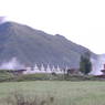 A row of stupas and a lone stupa with platforms and columns.
