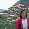 A Chinese woman with the monastery in the background.