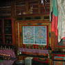 Two thangkha paintings behind a row of butter lamps