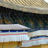 Close up of one of the palace's golden roofs and its cornice.