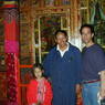 A young Tibetan-American girl, monk caretaker, and David Germano in front of one of the palace's shrines.