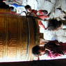 Children spinning a large prayer wheel.