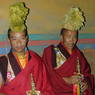 Two monk musicians dressed up with yellow hats (of the Geluk religious sect) and Tibetan clarinets (gyaling).