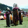 Three masked dancers performing in part of the courtyard.