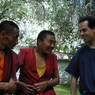 Two monks speaking with David Germano in the debate courtyard.