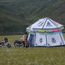 Tibetan women standing outside a tent.